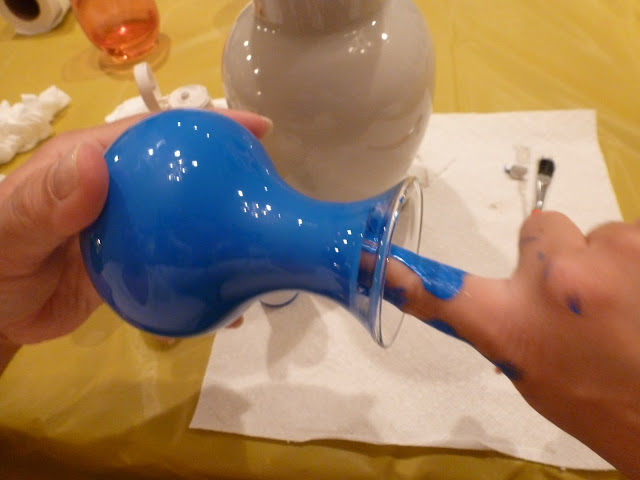 Using finger to paint inside the neck of a glass vase