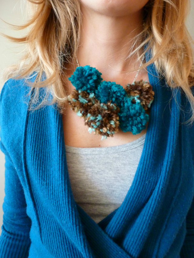 Woman wearing a blue pom-pom necklace