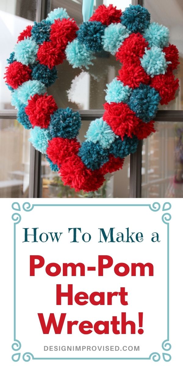 Pom pom heart wreath hanging on door