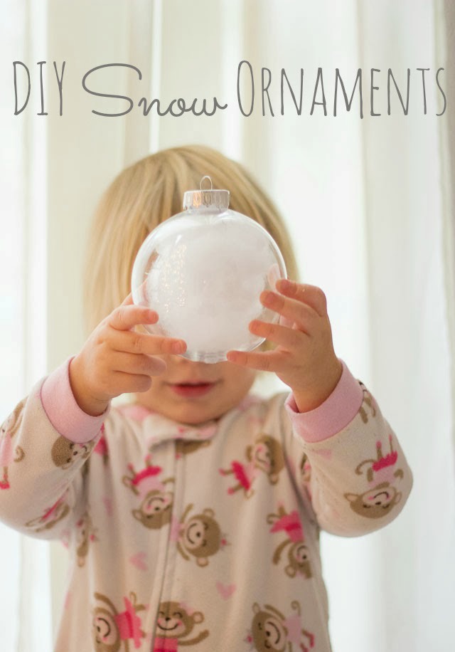 Child holding ornament filled with snow