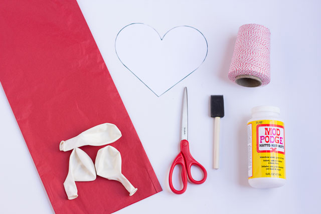 Make these DIY Valentine's Day heart balloons with Mod Podge and tissue paper!