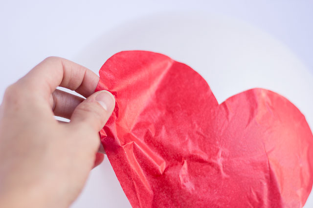 Make these DIY Valentine's Day heart balloons with Mod Podge and tissue paper!