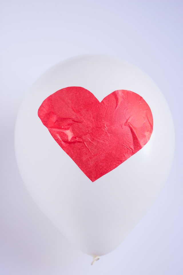 Make these DIY Valentine's Day heart balloons with Mod Podge and tissue paper!