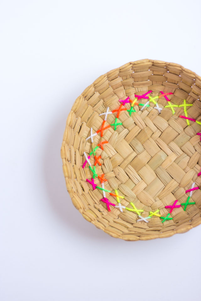 Give thrift store baskets a modern makeover by embroidering them with colorful yarn!