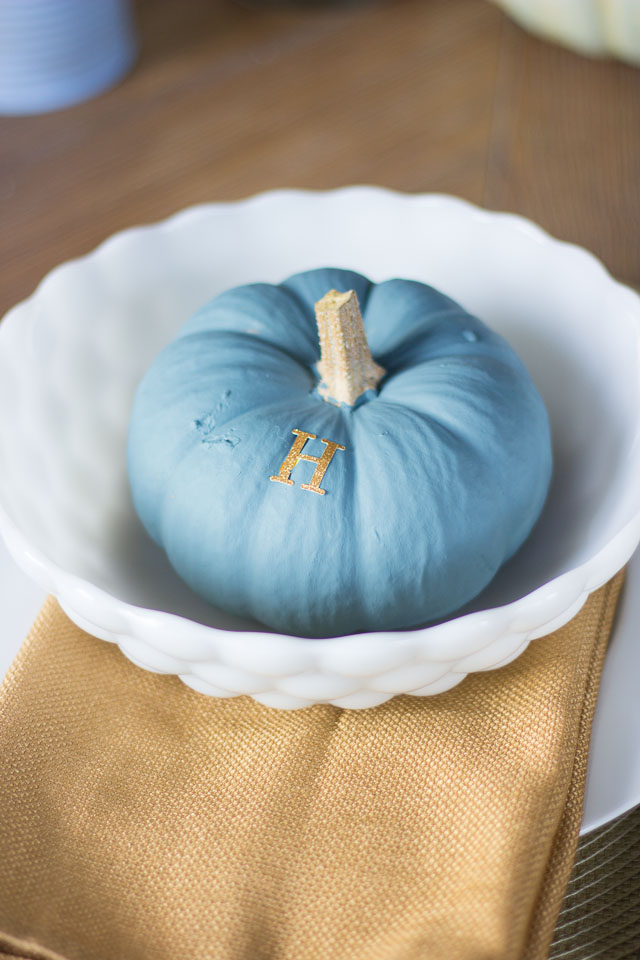 A modern Thanksgiving table with gold dipped feather arrangements and pumpkins painted in moody blues and greens || http://designimprovised.com