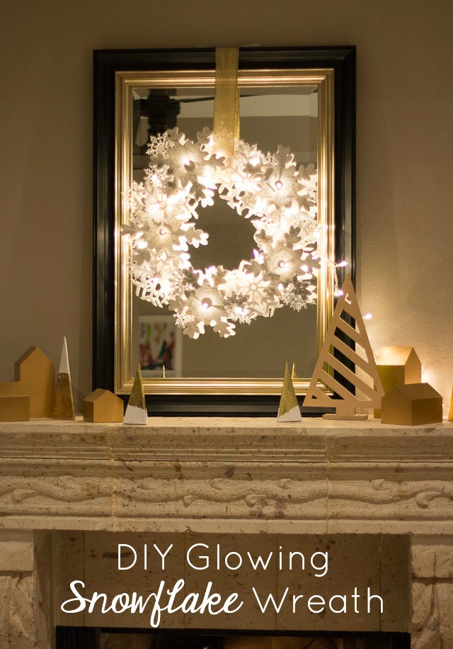Glowing snowflake wreath over fireplace mantel