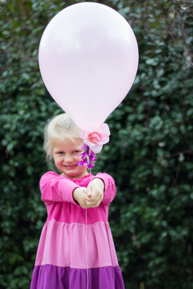 Combine artificial flowers with balloons for a gorgeous effect - perfect for weddings, showers, or a Valentine's Day bouquet! | http://www.designimprovised.com