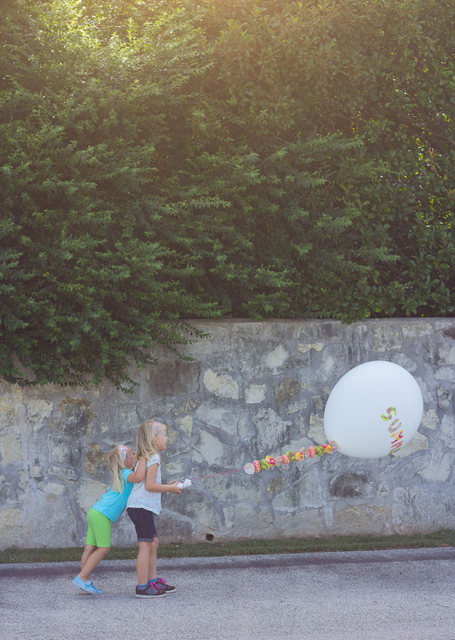 Decorate a balloon with cupcake liners - so fun!