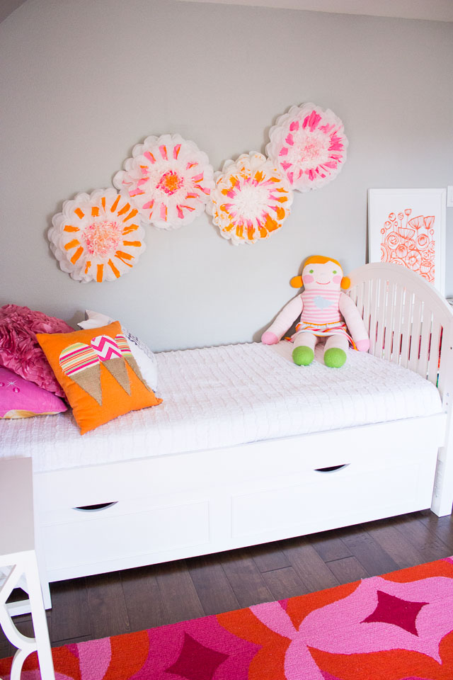 Tissue paper pom poms make for cute wall decor in kids bedrooms!