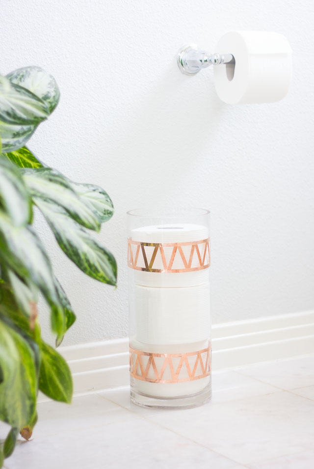 Transform an old vase into chic toilet paper storage!