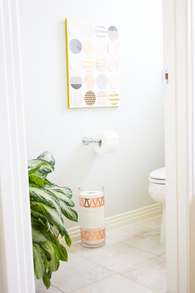 Transform an old vase into chic toilet paper storage!