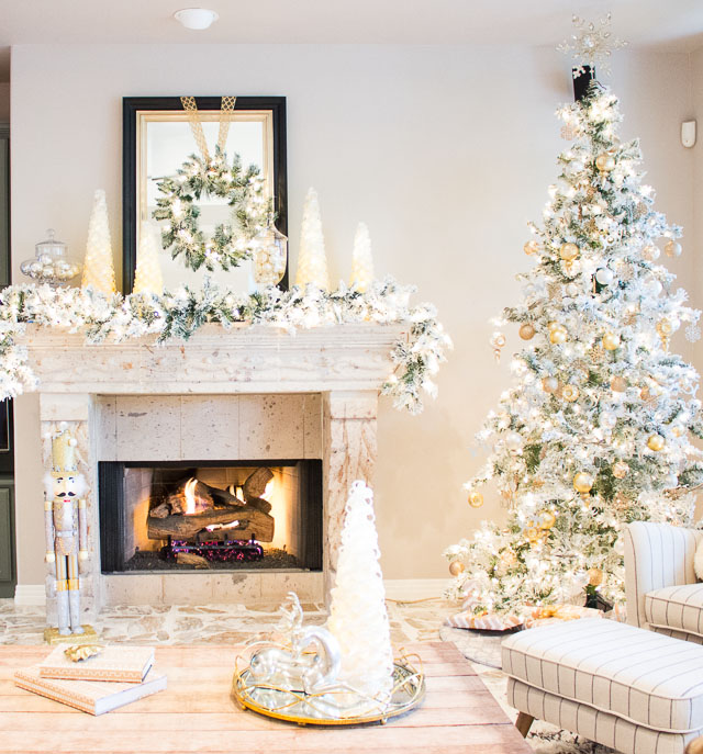 A Christmas wonderland living room with mixed metallics and flocked greenery!