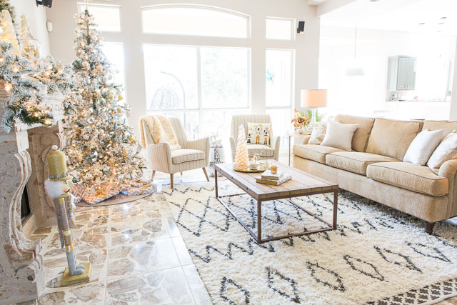 A Christmas wonderland family room with mixed metallics and flocked greenery!