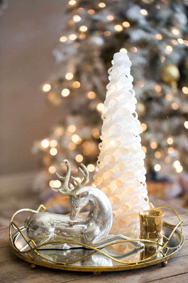 A Christmas wonderland living room with mixed metallics and flocked greenery!