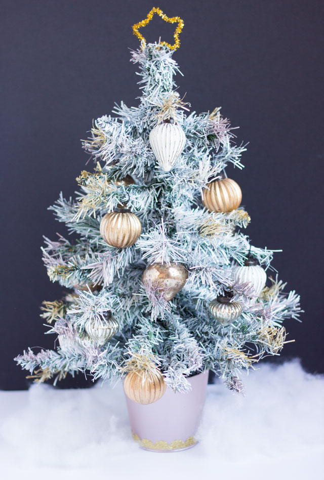 Tabletop painted Christmas tree with metallic ornaments
