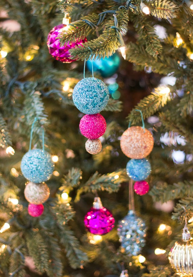 Glitter ball ornaments hanging from a Christmas tree