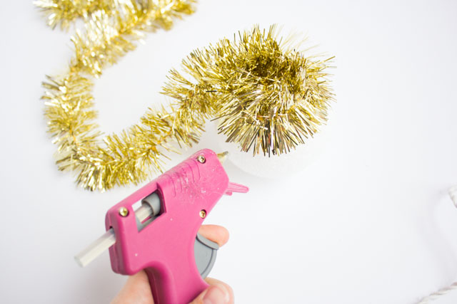 Homemade Christmas ornaments with tinsel garland