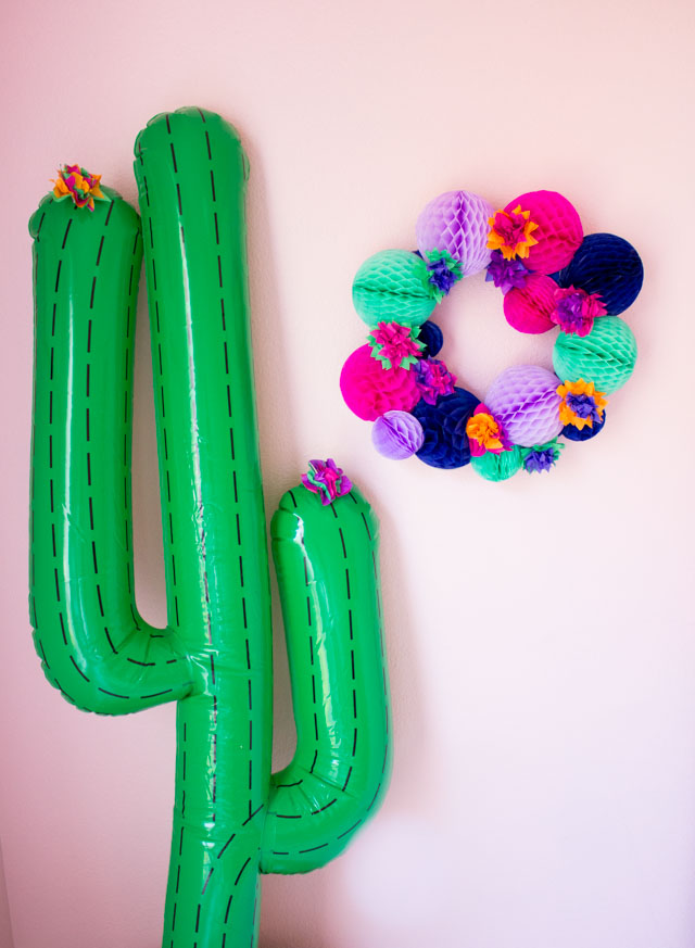 Pair this DIY fiesta wreath with an inflatable cactus for a perfect Cinco de Mayo party backdrop!