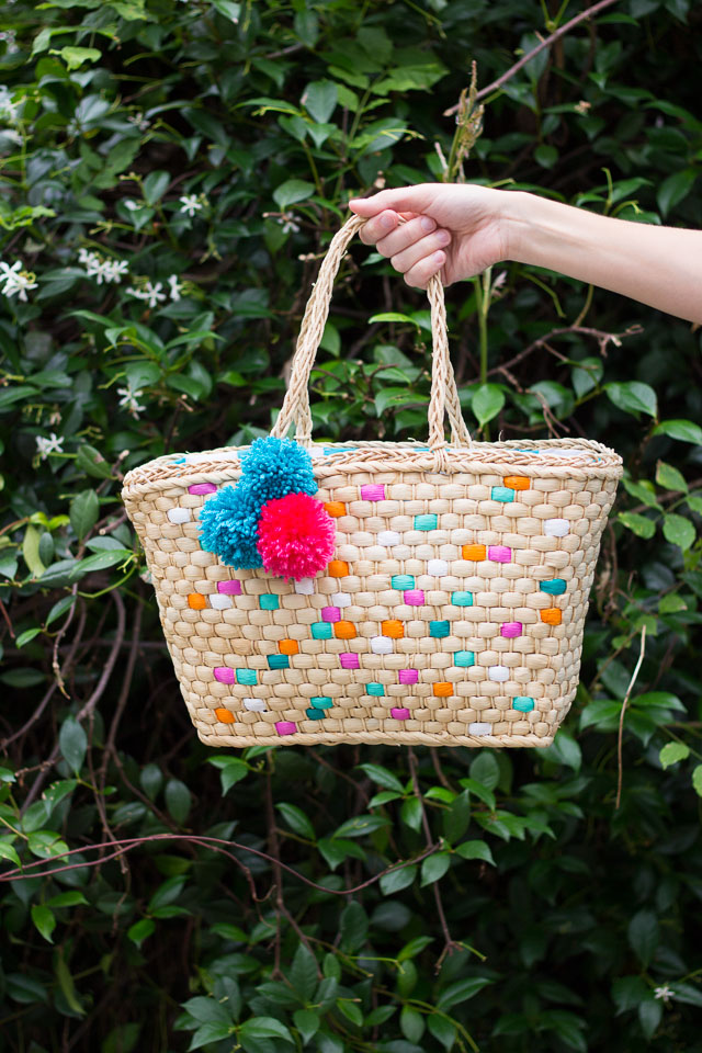Dress up a plain straw tote with pom-poms and paint - so fun for summer!