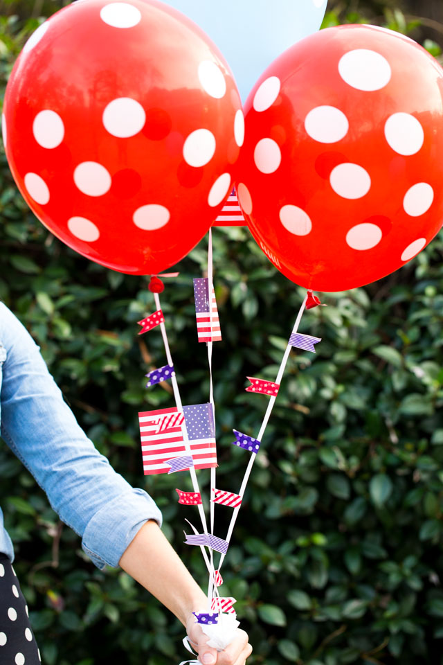 Decorate balloon strings with colorful washi tape for these DIY patriotic balloons!