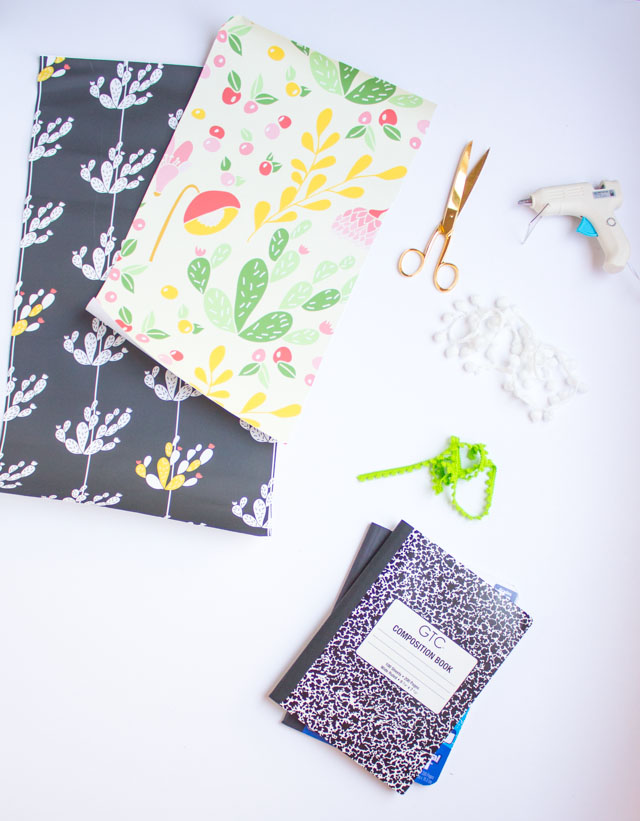 Supplies for DIY vinyl-covered pom-pom trim notebooks