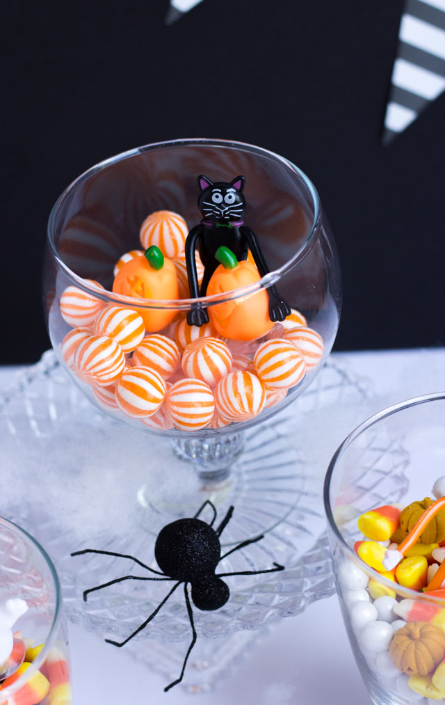 Fill glass jars with candy and small figurines for fun Halloween decor!