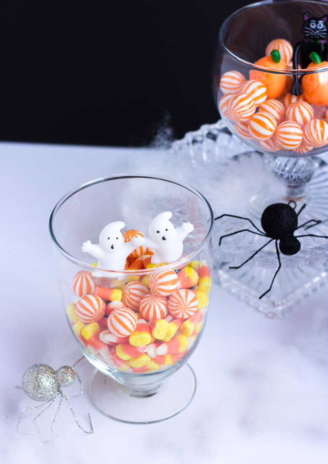 Fill glass jars with candy and small figurines for fun Halloween decor!