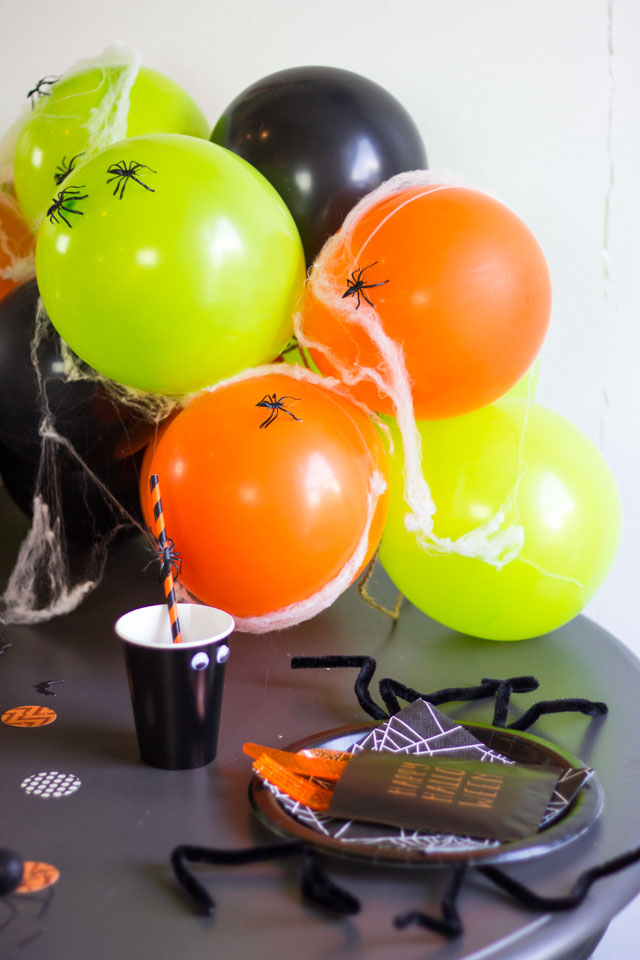 Cover balloons with spiders and spider webs for spooky Halloween decor!