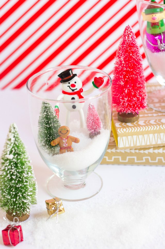 Fill glass jars with faux snow and mini Christmas toys for these sweet Christmas terrariums! Fill glass jars with faux snow and mini Christmas toys for these sweet Christmas terrariums!