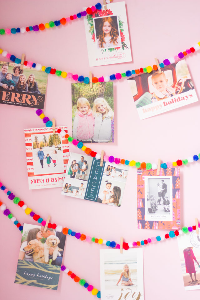 Love this colorful Christmas card display idea with pom-pom garlands!