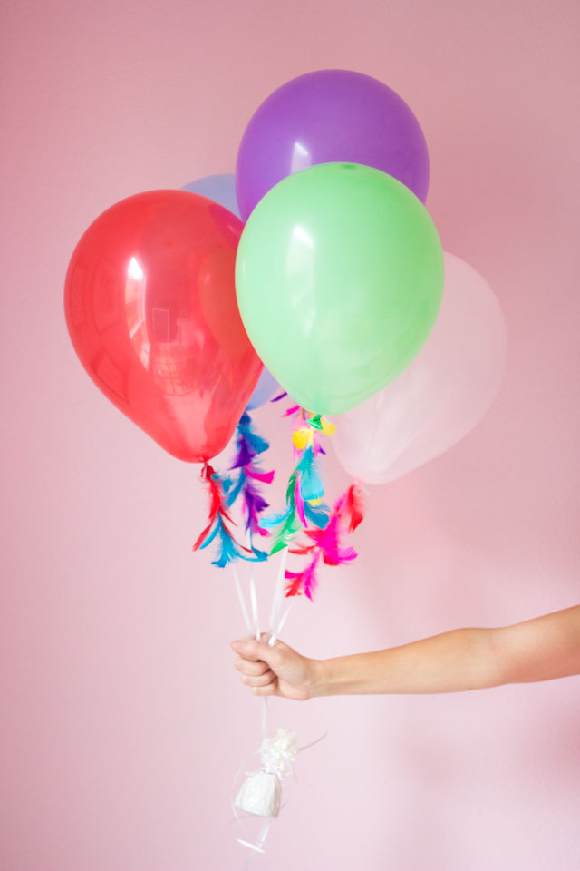 Decorate plain balloon strings with feathers - so pretty!