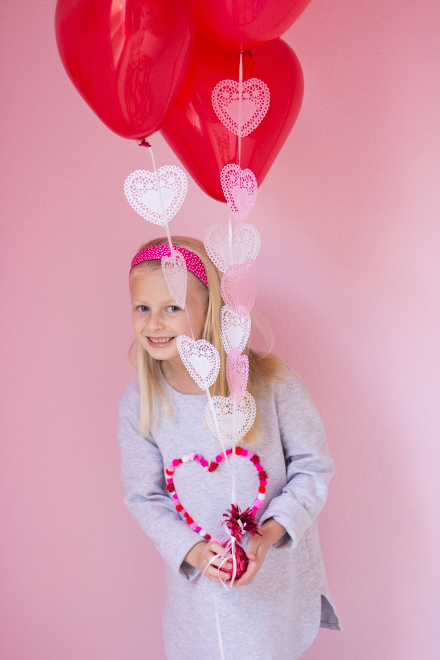 Add heart doilies to balloons to make the prettiest Valentine balloon bouquet!