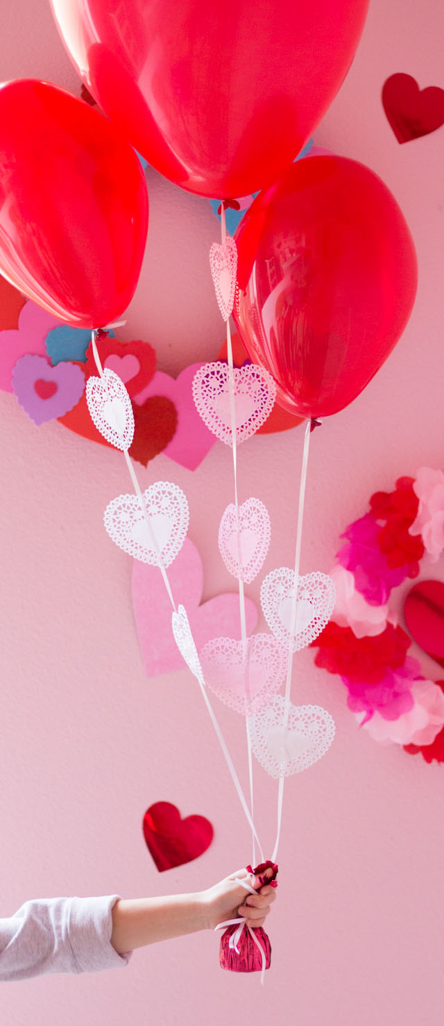 Add heart doilies to balloons to make the prettiest Valentine balloon bouquet!