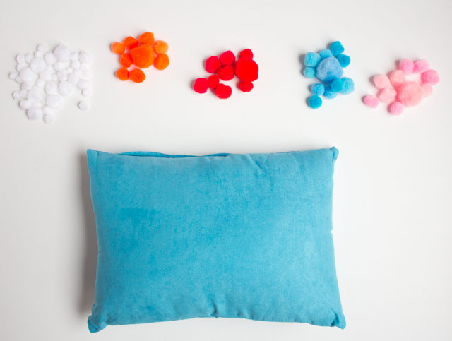 Decorate a pillow with pom-poms!