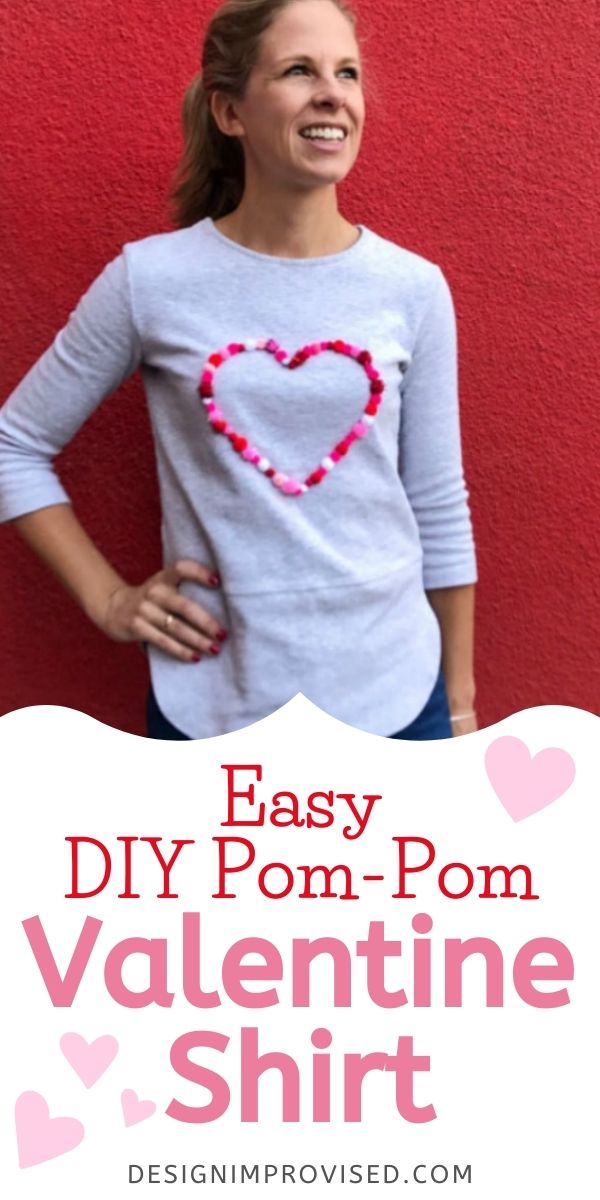 Shirt decorated with a pom-pom heart for Valentine's Day