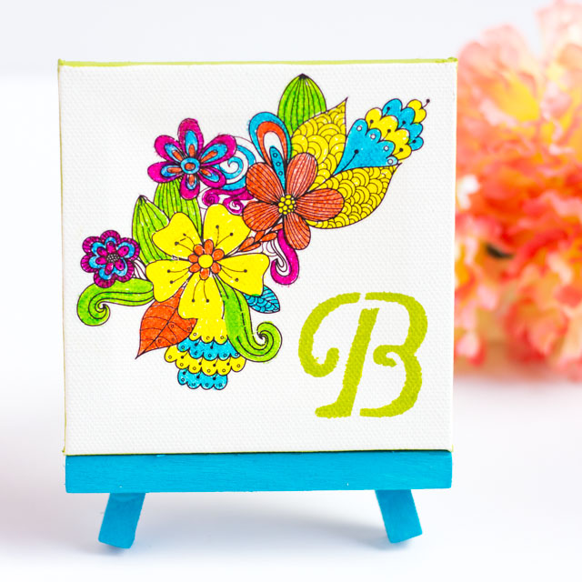 Make this monogram desktop art from mini canvases and floral rub-ons. A perfect personalized Mother's Day or birthday present!