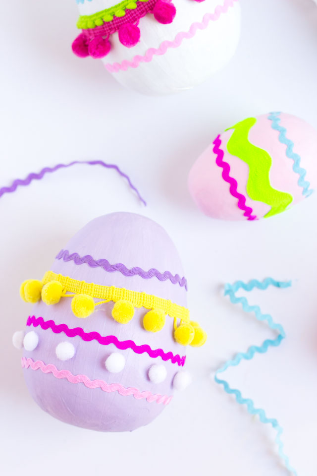 Make these colorful pom-pom and rick rack trim Easter eggs from giant paper mache eggs!