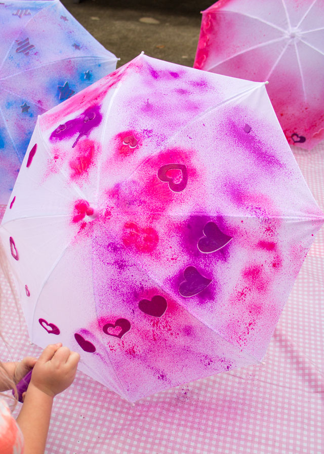 Make DIY kids umbrellas in a rainbow of colors with fabric spray paint!