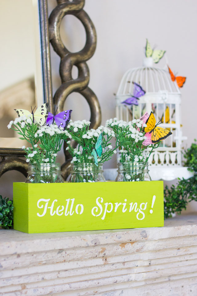 Make this spring flower box centerpiece with mason jars, butterflies, and faux baby's breath!