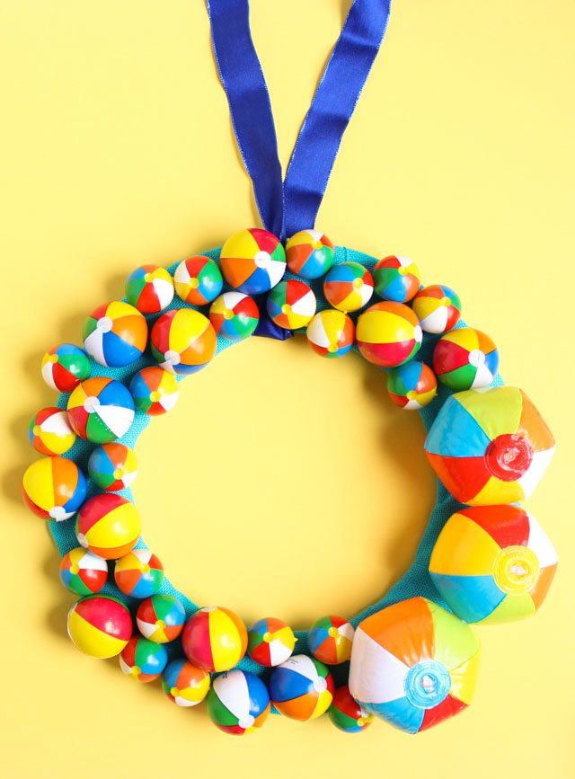 This wreath screams summer! Use mini beach balls to create a fun summer wreath for your front door or pool party!