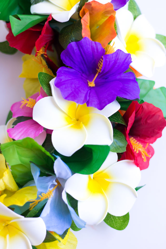 Make this DIY tropical flower wreath with faux hibiscus and plumeria!