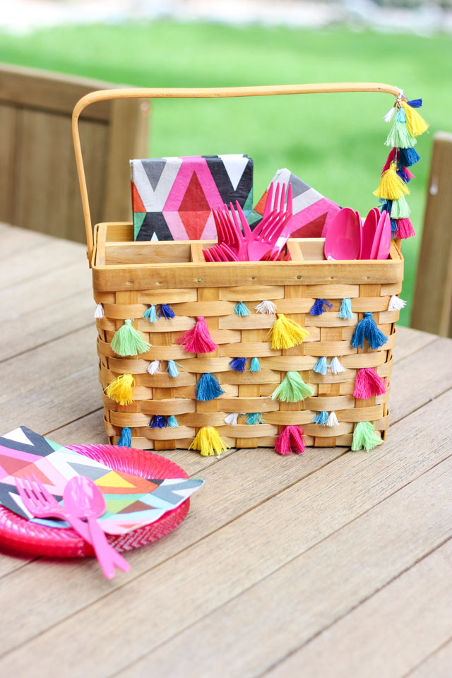 Decorate a basic picnic utensil basket with tassels for boho chic summer entertaining!