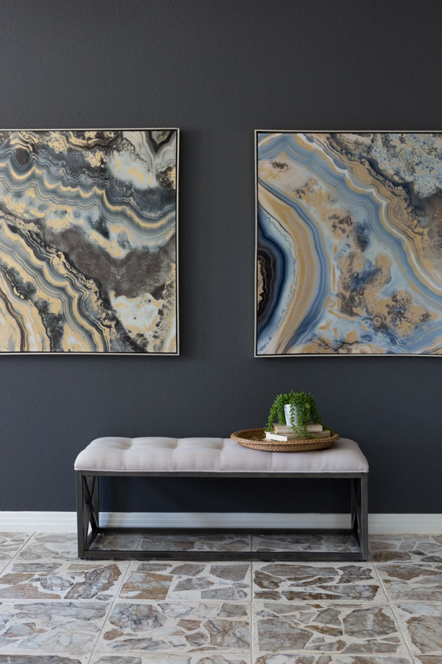 Create a high impact focal wall with large scale art and dark paint.