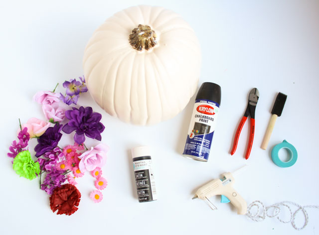 Make these DIY black flower pumpkins with dollar store flowers. The perfect mix of pretty and spooky for Halloween!