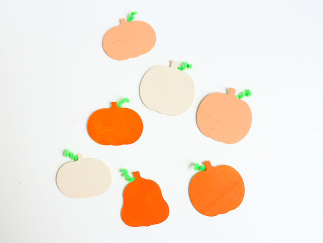 Painted wood pumpkins with pipe cleaner stems!