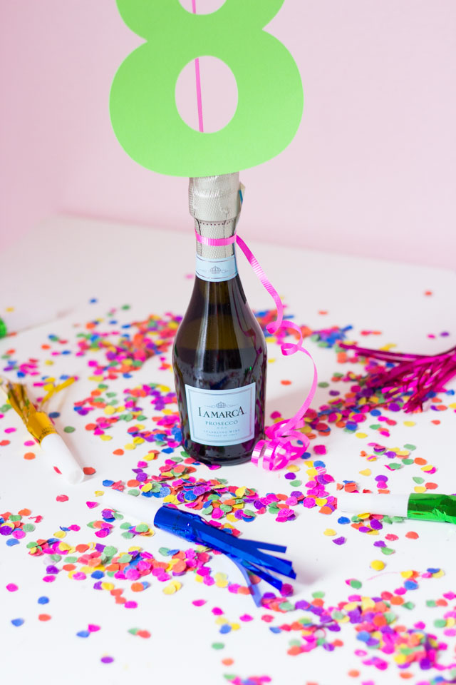 The perfect DIYt New Years Eve decoration - confetti filled number balloons with a champagne balloon weight!