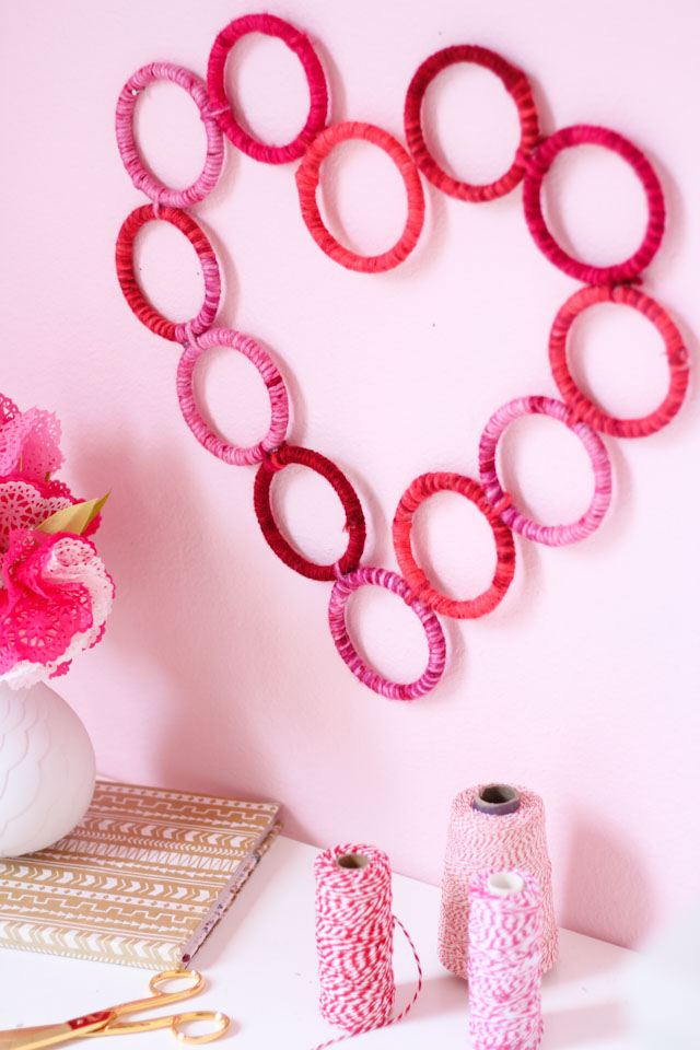 Make this yarn-wrapped heart wreath for under $10. Perfect for a Valentine's Day gift idea!