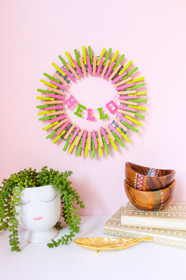 Hello Spring! This colorful DIY clothespin wreath is the perfect way to welcome spring to your home. #springwreath #clothespinwreath #clothespin #hellospring