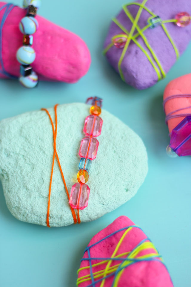 Rocks never looked so pretty! Decorate them with beads and jewels for pretty garden rocks or paperweights! #rockpainting #gardenrocks #kidscraft #naturecraft #kidmademodern