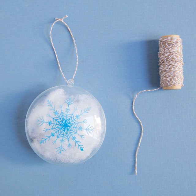 Stencil clear ornaments with snowflakes and fill them with snow! #christmasornaments #snowflakeornaments #clearornaments #marthastewartcrafts #plaidcrafts